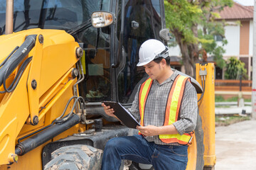 Construction engineer inspecting heavy machinery clipboard at building site wearing safety helmet reflective vest for equipment inspection maintenance project management © JP.Studio
