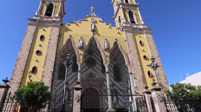 View of the yellow facade and twin towers of Catedral Basilica de la Inmaculada Concepcion in Mazatlan, Sinaloa, Mexico.