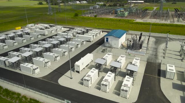Modern battery energy storage system with containerized battery modules for storing electricity next to a high voltage substation, representing a key solution for renewable energy