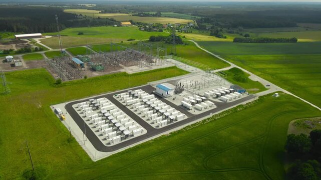 Modern battery energy storage system facility with containerized modules and an electrical substation for renewable energy distribution, showcasing innovative solutions for a green future