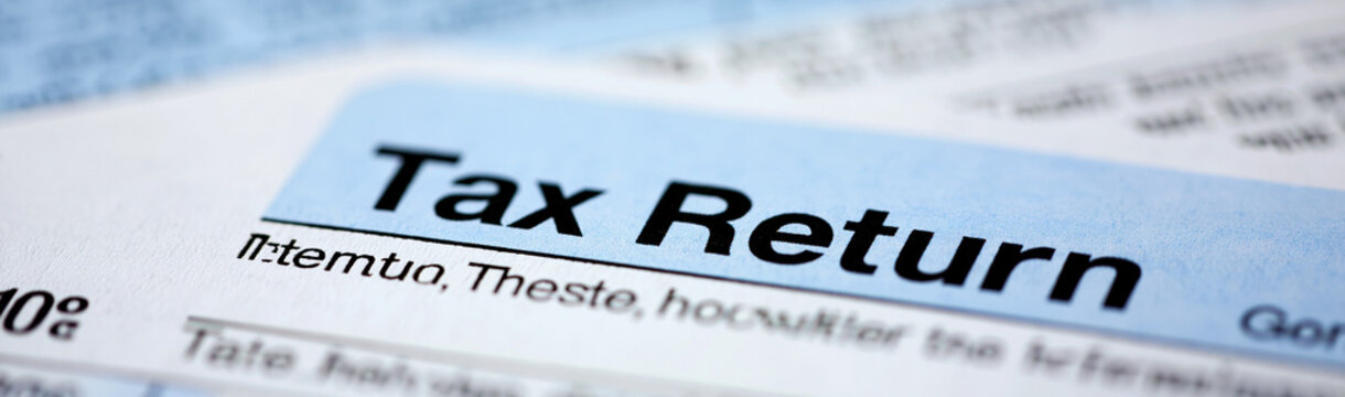 Tax Return Form Detail: A close-up view of a tax return form, emphasizing the title Tax Return and hinting at financial documentation.