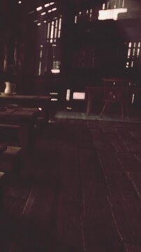 Sunlight shines through wooden beams in a room filled with empty chairs and tables. This setting exudes a vintage vibe with weathered wood and minimal decor.