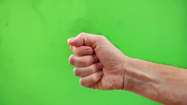 Close-up of hand giving thumbs-up gesture on vibrant green background, slow motion, symbolizing approval, success, and positivity
