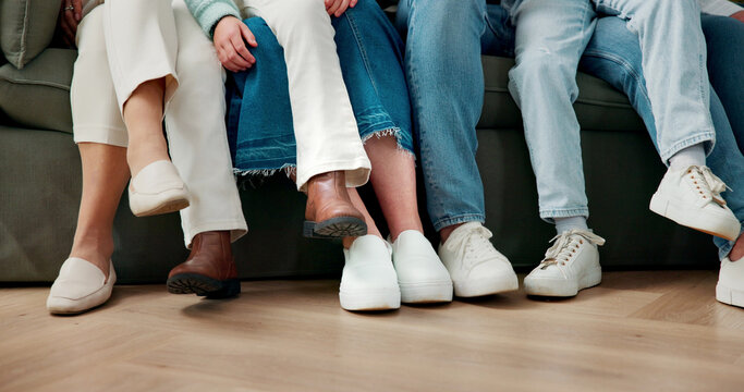 Legs, family and relax on sofa for bonding together, kids and parents on break with connection in house. Shoes, children and people on couch in living room, chill or love with comfort at home