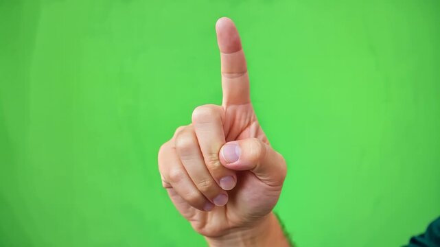 Close-up of hand pointing index finger upwards against vibrant green background, symbolizing focus, direction, and emphasis for presentations and marketing content
