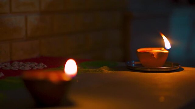 Closeup shot of Diya oil lamp on a wall of the Indian home during the Deepavali festival in India. Diwali background with copy space. Oil Lamp decoration on home during the Diwali festival. 