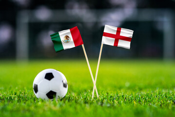 Mexico vs England, national flags before international football match, football on green grass with...