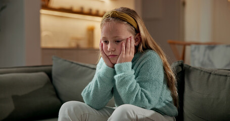 Sad, child and thinking in home with loneliness, boredom and mental health crisis in lounge....