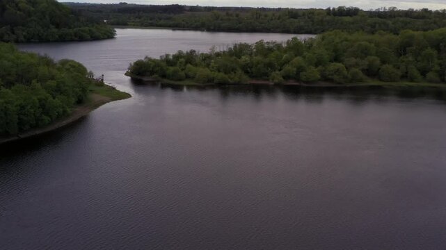 Aerial drone footage of Lough Oughter fishing spot, lush greenery with anglers, County Cavan Ireland
