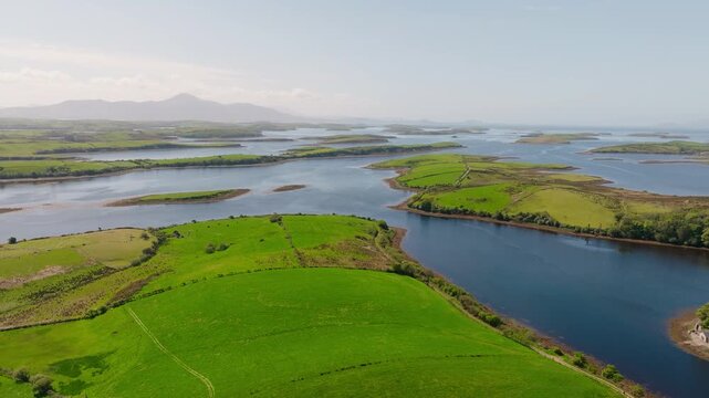 Breathtaking aerial drone shot of the unique Clew Bay and its many drumlin islands in County Mayo, Ireland. Panoramic view with the famous holy mountain Croagh Patrick in the background.