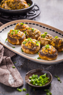 Delicious stuffed mushrooms with cheese and herbs served on a platter