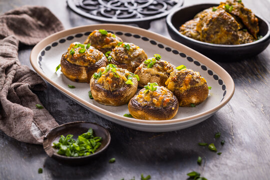 Delicious stuffed mushrooms with cheese and herbs served on a platter