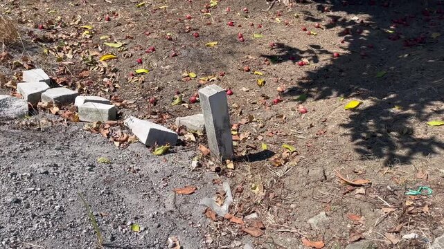 Broken Concrete Land Boundary Marker on Arid Property Ground