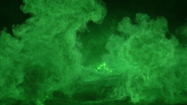 Abstract green smoke and dust particles billowing on a dark background