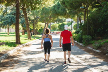 Fototapeta premium Senior couple enjoying an outdoor fitness walk together in a green park