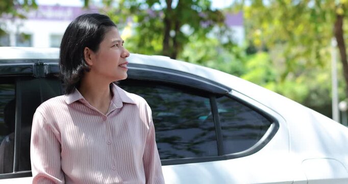 Stressed woman beside a car outdoors, Businesswoman missed career goals, representing frustration, unemployment, anger, pressure, waiting and failure, Thai Asian woman