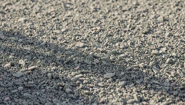 Medium shot highlighting light gray cool roof granules spread evenly demonstrating their effectiveness in reducing roof heat absorption with subtle color variation.