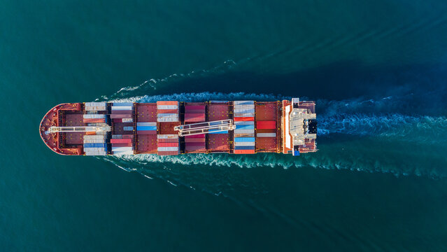 cargo container ship fully loaded transportaion colorful shipping containers navigates through deep blue ocean waters, leaving a wake as it transports goods global maritime logistics 