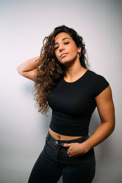 Young woman with curly hair looking at camera posing