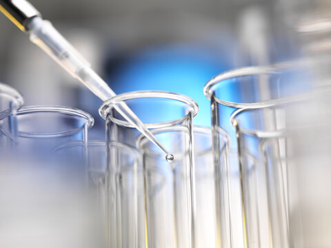 Scientist pipetting a sample into a test tube during a experiment in the laboratory