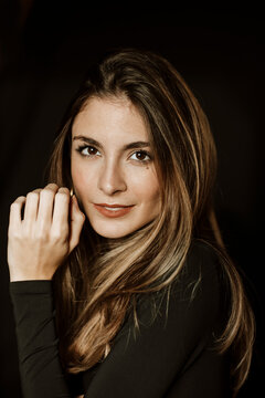Elegant portrait looking at camera on black background