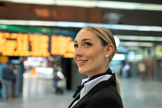 Thoughtful female flight attendant looking away at airport