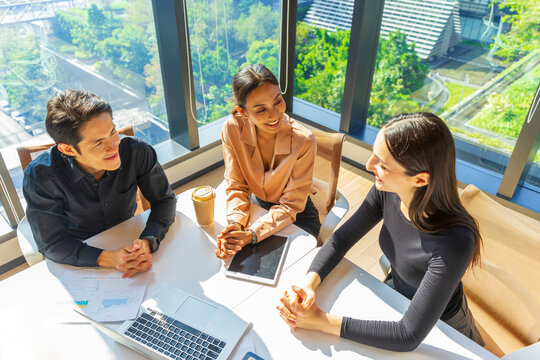 Group of Multiethnic business people discussing business plan at meeting room. Businessman and businesswoman having a discussion in modern office.
