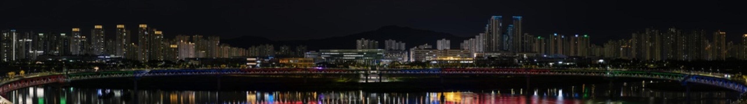 Sejong City Night Panorama with Eungdari Bridge(Geumgang Pedestrian Bridge) Illumination Reflecting on Geumgang River.