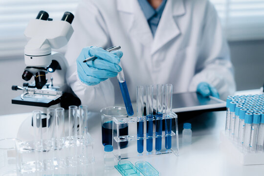 Scientists study biochemical samples in a lab for health care