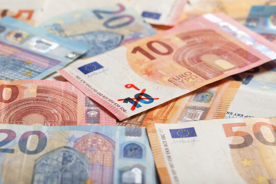 Ten euro banknote with number 9 written on it symbolizing devaluation of currency