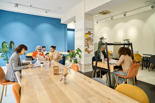 Colleagues planning and communicating in modern coworking space