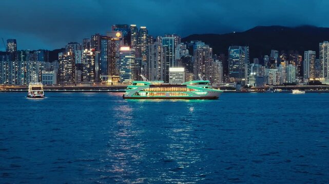 A bustling cityscape at night with modern high-rise buildings and a large ferry moving gracefully across the harbor