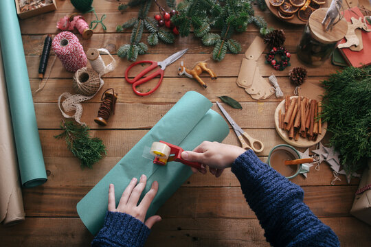 Woman's hands wrapping christmas gifts