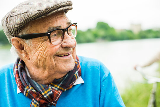Happy senior man with glasses and cap