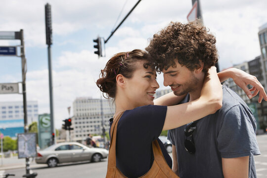 Couple hugging and smiling on a city street in Berlin