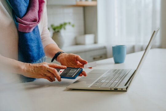 Customer paying online with smartphone and credit card at home