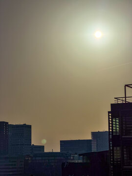 Smoggy Urban Skyline with Hazy Sun Over City Buildings &ndash; Antwerpen, Belgi&euml;