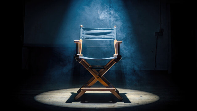Director's Chair Under Spotlight in Dark Studio