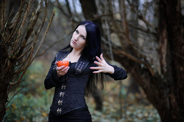 Obraz premium A woman in a witch suit in a forest