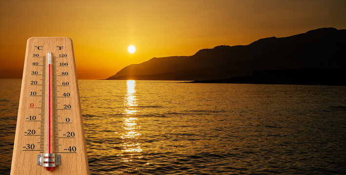 Temperatures rising by the sea. Global warming concept. Thermometer at 40 degrees. 