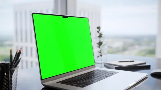 Laptop Green Screen Mockup on Desk in Modern Executive Office Interior - Perspective Close Up View