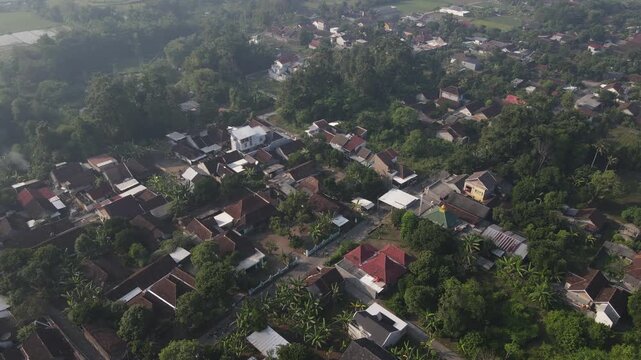 aerial footage of a cycling group passing through rural roads.