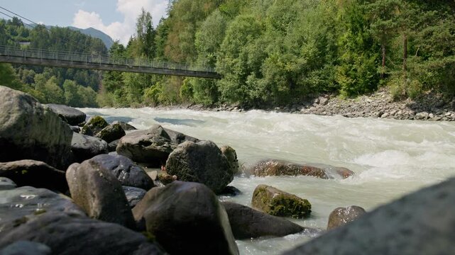 Wild alpine river Otztaler Ache crossing picturesque mountain landscapes in Austria offering stunning scenery for travel and outdoor exploration