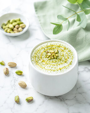 Pistachio Latte with Honey Drizzle and Matcha Powder on Marble, Gourmet Breakfast Drink Top View