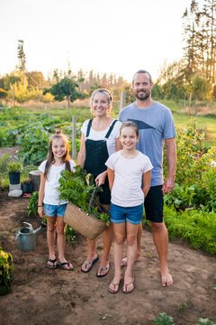 Family of four pose for photo in their backyard garden
