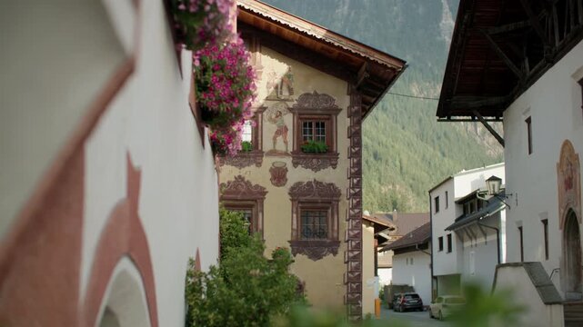 Architecture of alpine villages in Oetz valley, Tyrol, Austria. Historic houses on the streets of Umhausen, city landscapes, travel and tourism in Europe.