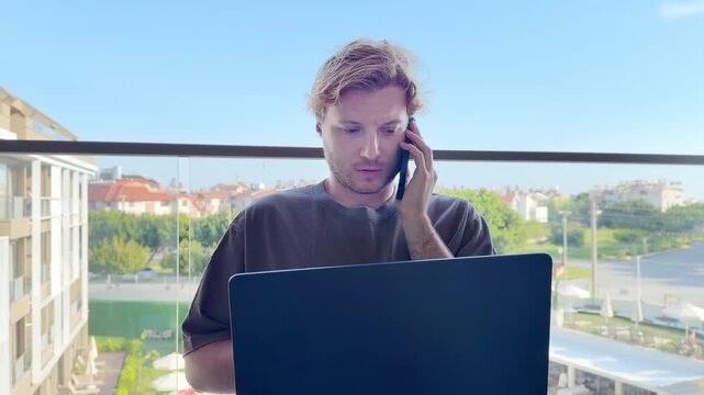 Young man working on computer at home,works remotely at a computer at home.