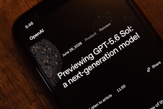 Mexico City, MEXICO - Jun 30 2026 : Close-up of a smartphone displaying an OpenAI GPT-5.6 release page, a next-generation model, on a dark wooden surface.