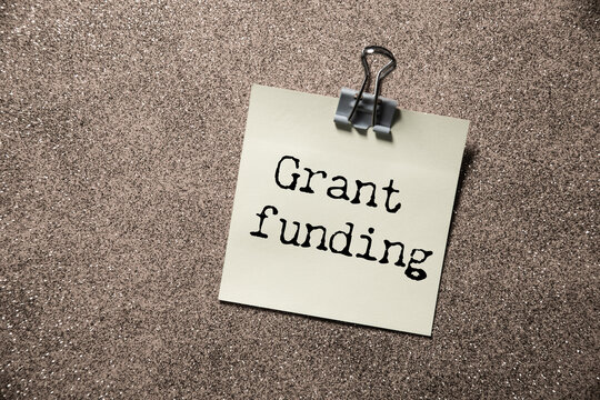 Grant funding symbol. text on a page