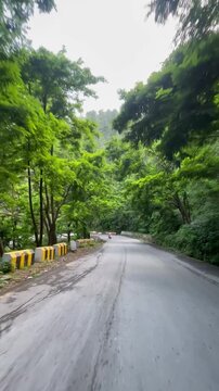 Scenery of greenery at Blue sky with this neat and clean road with mountains, Video taken on Haripur road Khyber Pakhtunkhwa, This view is caputure from the bike.